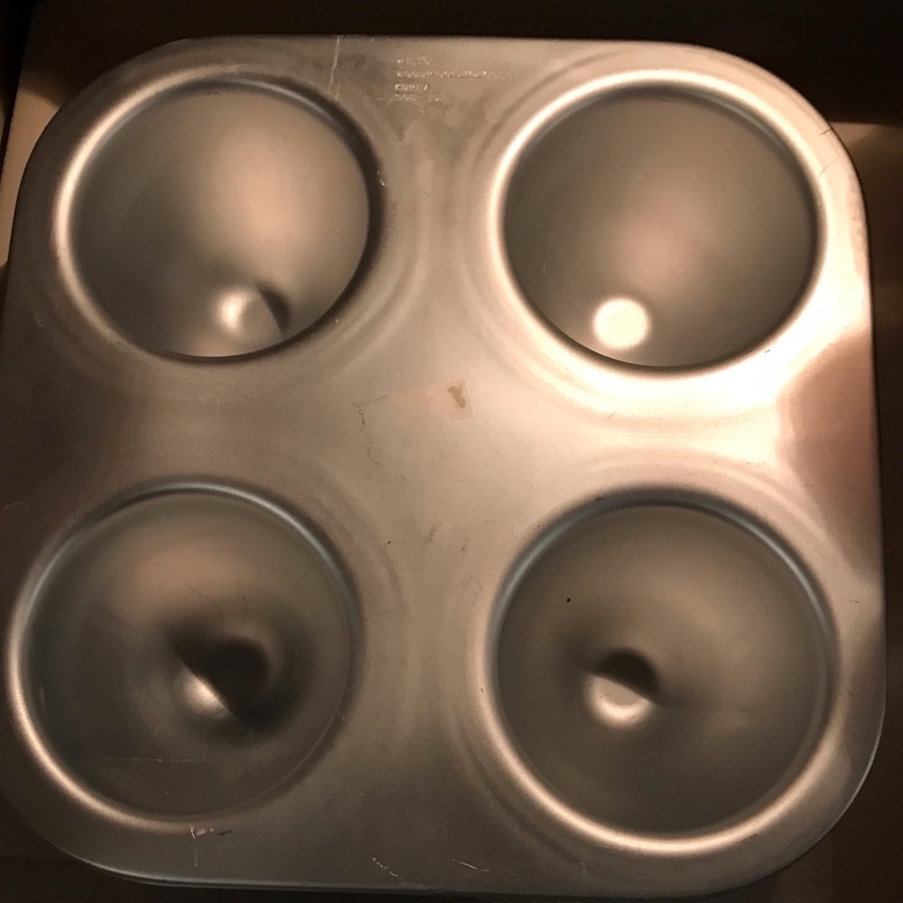 Wilton 1/2 breast or egg shaped Cake Pan with four (4) molds. Good used.